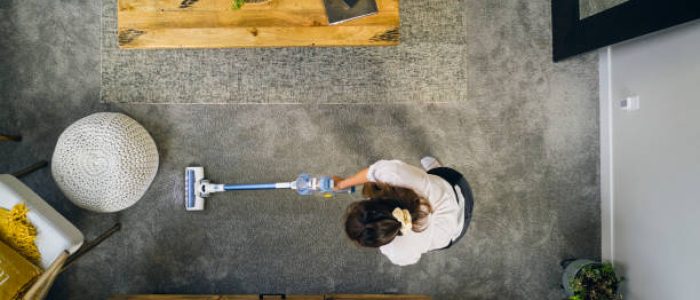 A professional housecleaner at work cleaning a home.